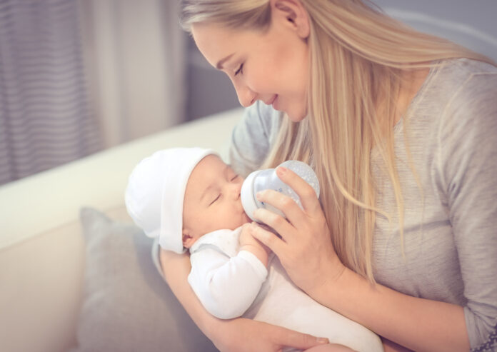 Happy mother feeding baby
